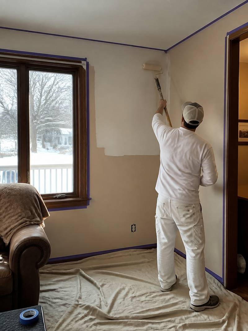 Interior wall being professionally painted in winter